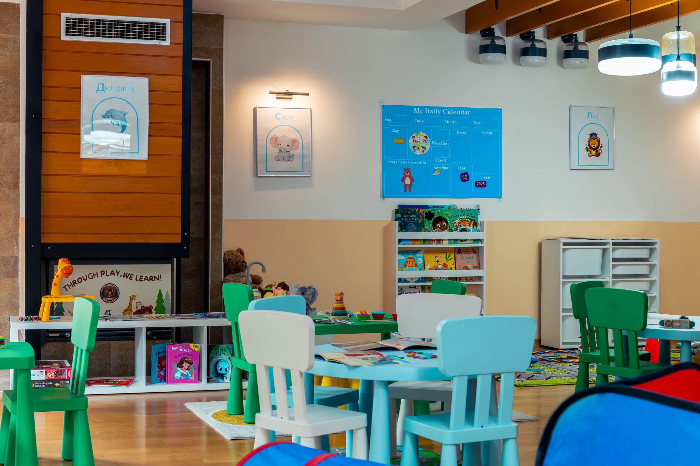 Our main classroom with child-sized tables and reading shelves