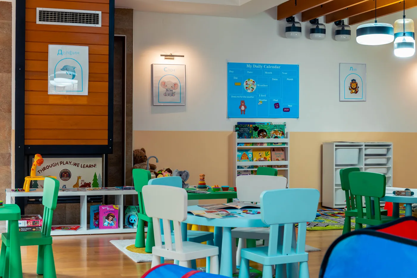 Our main classroom with child-sized tables and reading shelves